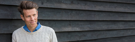 Panoramic portrait shot of an attractive, successful and happy middle aged man male outside panorama web bannerの写真素材