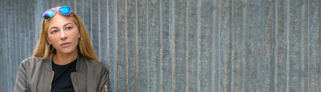 Panorama outdoor portrait of pretty sad thoughtful blonde girl teenager female young woman panoramic web bannerの写真素材