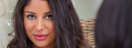 Panoramic beautiful Hispanic Latina mixed race mixed race, biracial, african american, woman looking over the shoulder of a female friend panorama web banner headerの写真素材