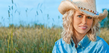 Outdoor portrait of smiling and happy, beautiful young female teenager with blonde hair wearing...