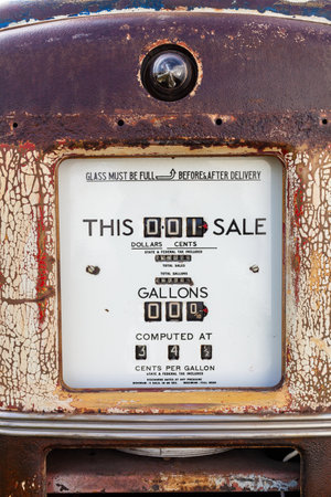 Rust old fashioned vintage petrol, gas or gasoline fuel pump with volumes in Gallons and prices in Dollars and Centsの写真素材