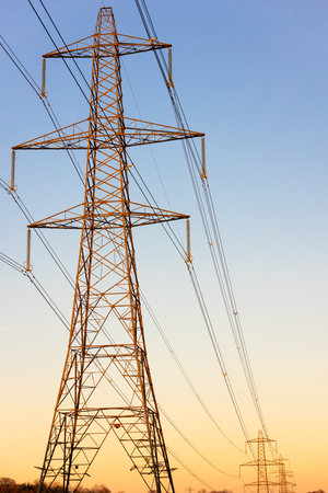 Electricity Pylons of the National Grid at Sunset or Sunriseの写真素材