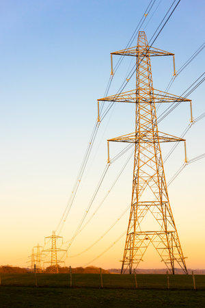 Electricity Pylons of the National Grid at Sunset or Sunriseの写真素材