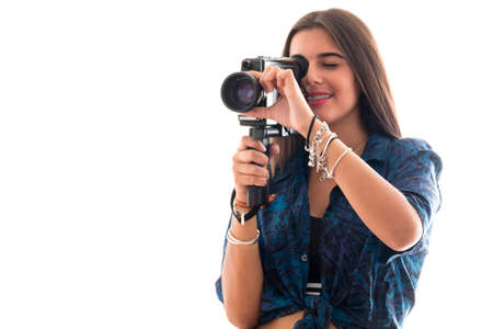 young girl posing with an old film camera on white backgroundの写真素材