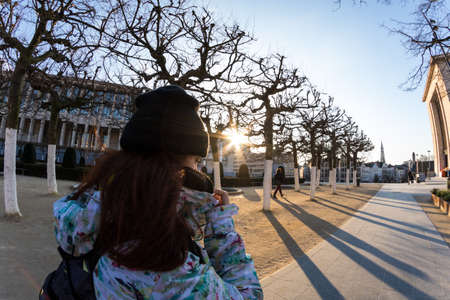 Redhead young woman walking in the street, dressed very warm, in winterの写真素材