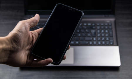 hand of senior person using a modern mobile in a workspaceの写真素材