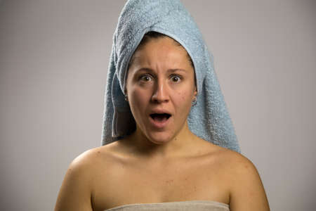 Girl after shower with a towel and scared and sadの写真素材