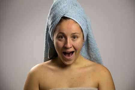 Shy girl screaming after taking a showerの写真素材