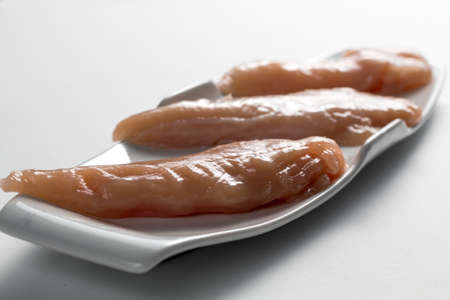 Raw chicken Breasts on a white table. Modern white plateの写真素材