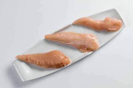 Raw chicken Breasts on a white background. Modern white plateの写真素材