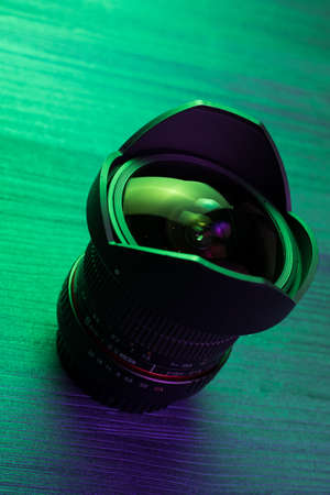 Fish eye lens. Wood table. Green lightの写真素材