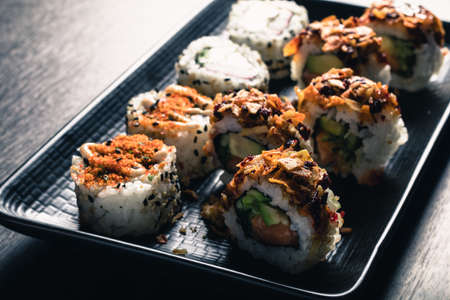 close up of sushi rolls on black trayの写真素材