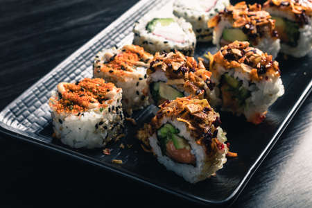 close up of sushi rolls on black trayの写真素材