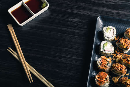 Sushi rolls with chopsticks and soy sauce on dark background. Space textの写真素材
