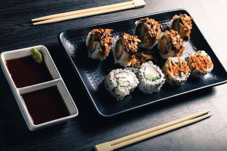 close up of sushi rolls on black trayの写真素材