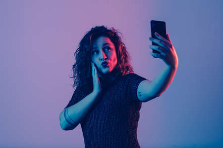 young girl making selfie and sending kissの写真素材