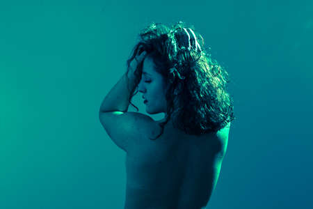 Emotional portrait, a girl in various emotional poses. Like under water. Studio shot. Copyspaceの写真素材
