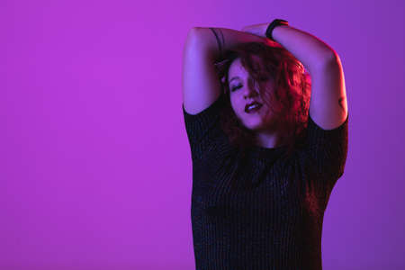 girl posing, studio shot. Face expression and colorful lightの写真素材