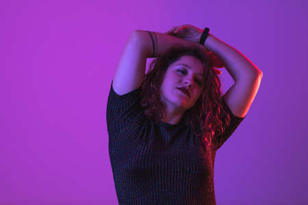 girl posing, studio shot. Face expression and colorful lightの写真素材