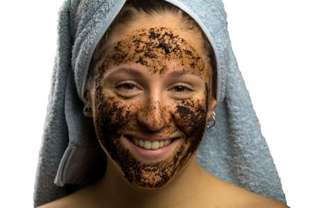 Girl after shower with a towel and different facial expressions, face with homemade coffee creamの写真素材