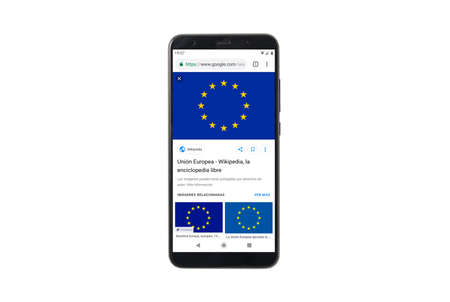 Granada, Spain; February 14, 2019: Europe news on mobile screen. Mock up mobile phone isolated on white background. Mockup top viewのeditorial素材