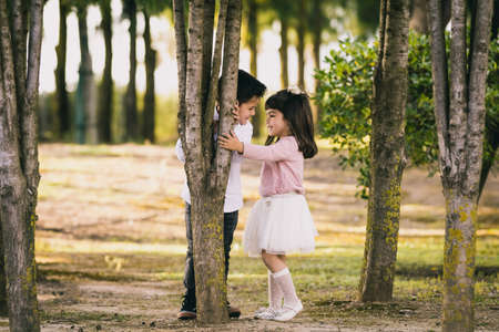 Girl and boy in the park. Face to faceの写真素材