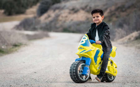 Little boy riding on motorcycle toyの写真素材