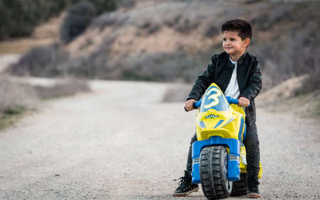 Little boy riding on motorcycle toyの写真素材