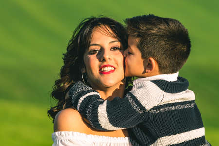 Woman and boy on nature over summer field background. Poses on natureの写真素材
