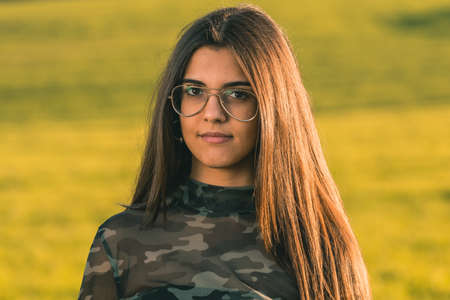 Pretty young woman on nature background - close up face portraitの写真素材