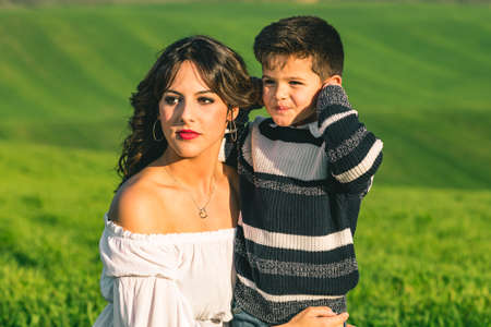 Woman and boy on nature over summer field background. Poses on natureの写真素材