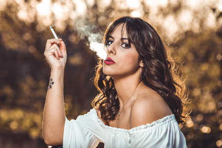 young girl posing and smokingの写真素材