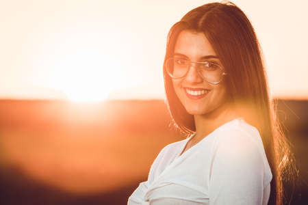 Woman smiling with perfect smile and white teeth in a park and looking at cameraの写真素材