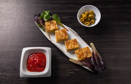 Spanish tapa, omelette, olives and sauceの写真素材
