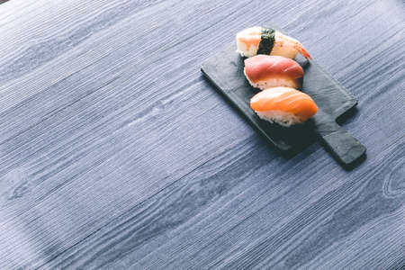 Sushi on wood table. Elegant japanese restaurant. Retro styleの写真素材