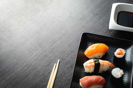 Nigiri sushi on wood table in a japanese restaurant. Copy space and top viewの写真素材