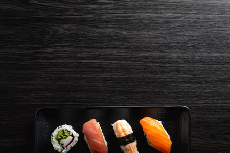 Nigiri sushi on wood table in a japanese restaurant. Copy space and top viewの写真素材