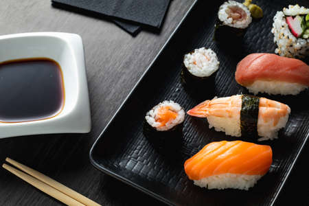 varied sushi plate on wood tableの写真素材