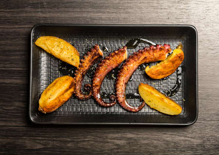 octopus tentacles grilled with potatoesの写真素材