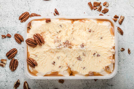 ice cream with ground nuts on white concrete tableの写真素材