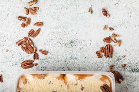 ice cream with ground nuts on white concrete tableの写真素材