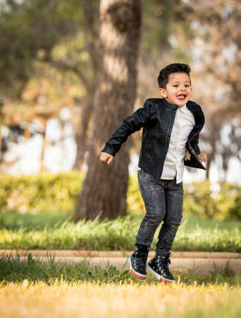 Boy posing in the park. Different expressions. Jumpingの写真素材