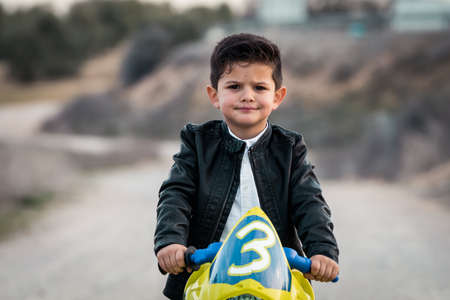 Little boy riding on motorcycle toyの写真素材