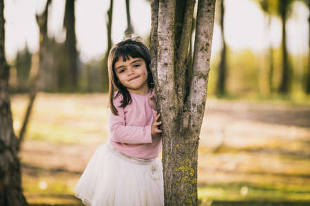 little girl playing and posing in a parkの写真素材