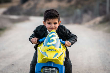 Little boy riding on motorcycle toyの写真素材