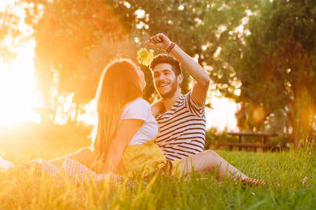 Portrait of a happy pregnant couple at a picnic.の写真素材
