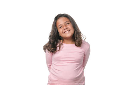 Portrait of a little brunette girl posing isolated on white background.の写真素材