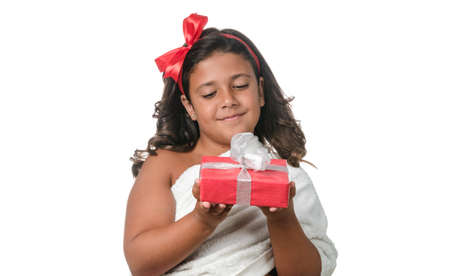 Happy little girl with a gift on white backgroundの写真素材