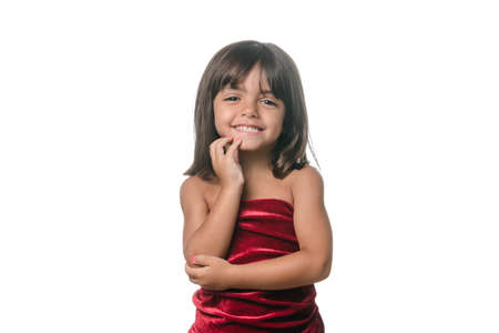 Little girl posing with red velvet dress on white backgroundの写真素材
