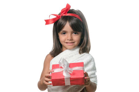 Happy little girl with a gift on white backgroundの写真素材